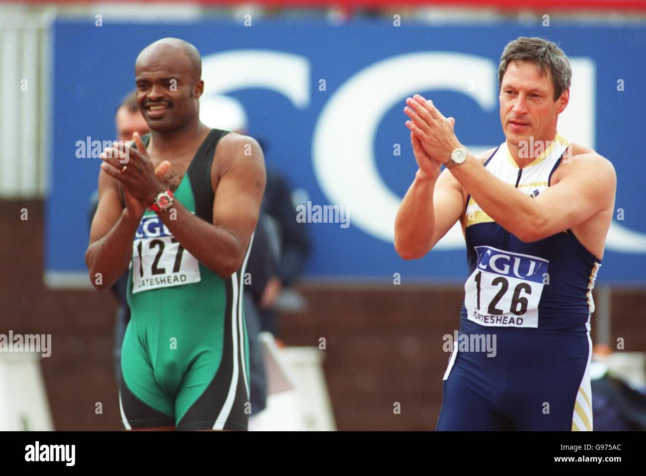 Athletics - CGU Gateshead Classic. Kriss Akabusi (left) and Alan Wells (right) applaud the crowd before taking aprt in the masters 100m event Stock Photo