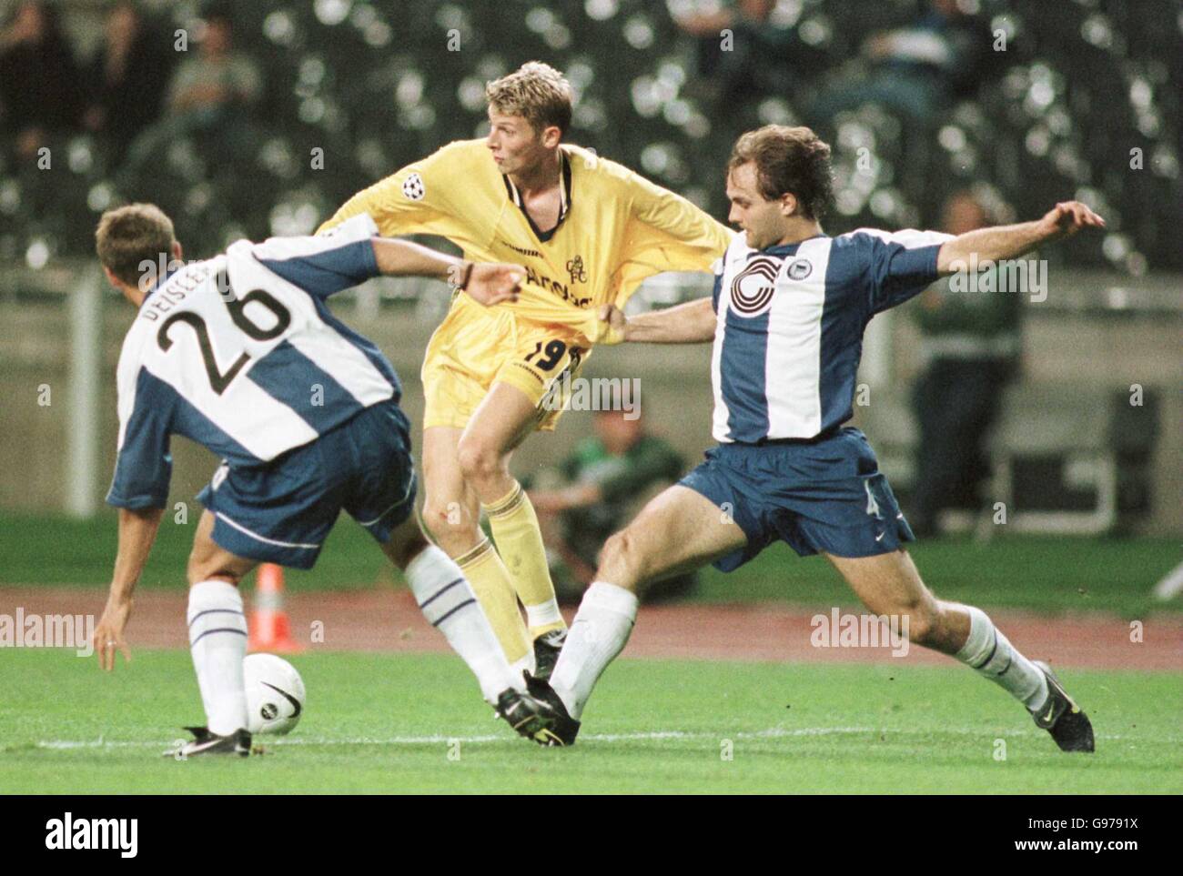 Chelsea's Tore Andre Flo (c) is challenged for posession of the ball by ...