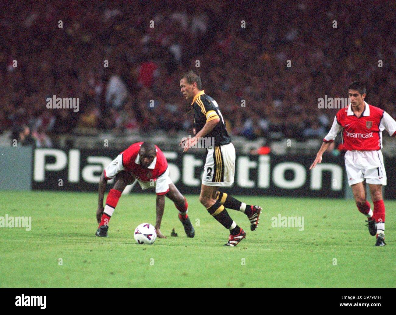 Soccer - UEFA Champions League - Group B - Arsenal v AIK Solna. AIK Solna's Krister Nordin (centre) is watched closely by Arsenal's Patrick Vieira (left) Stock Photo