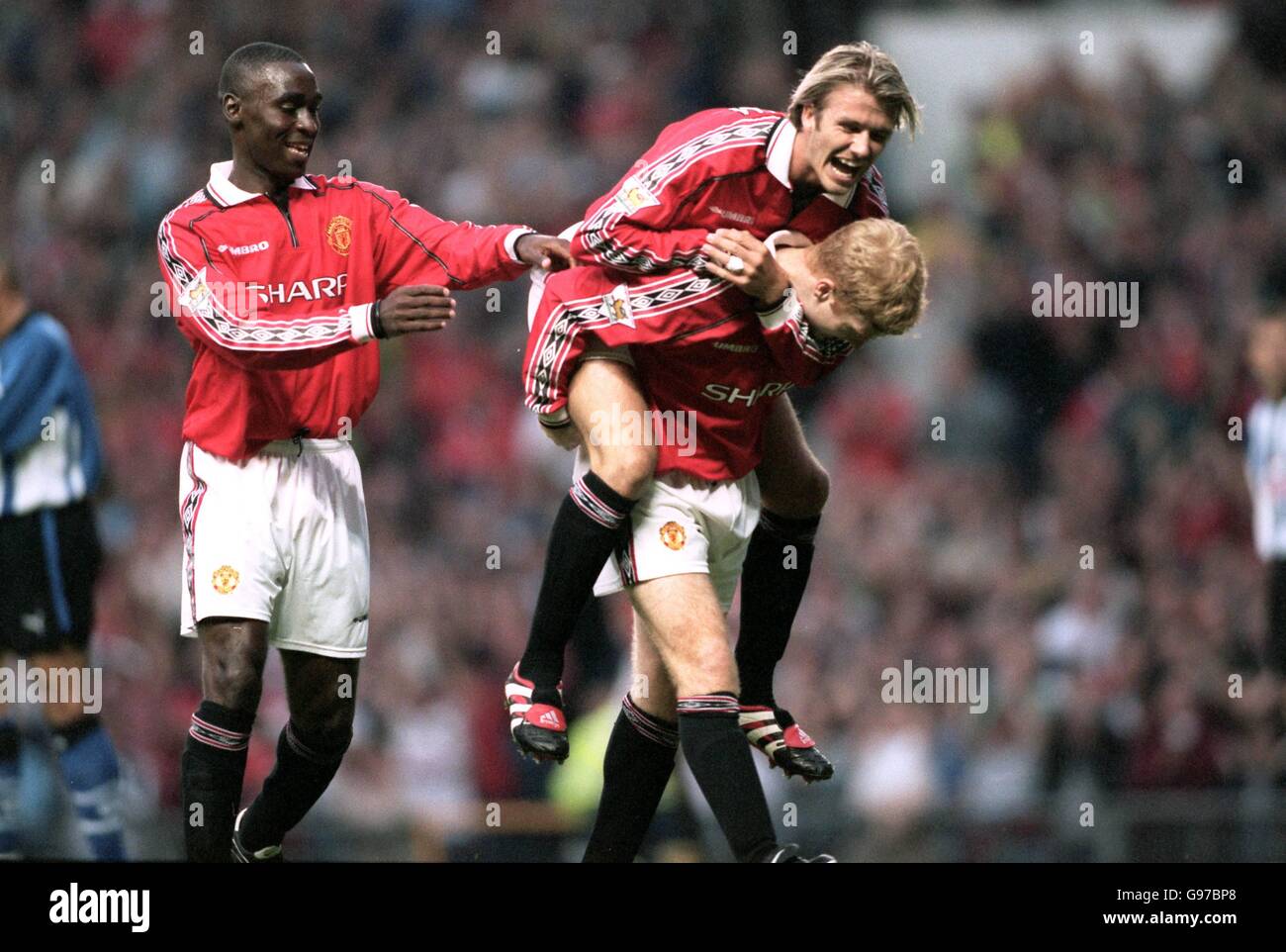Manchester United's Paul Scholes gives David Beckham a lift after scoring United's first goal against Sheffield Wednesday as Andy Cole looks on Stock Photo