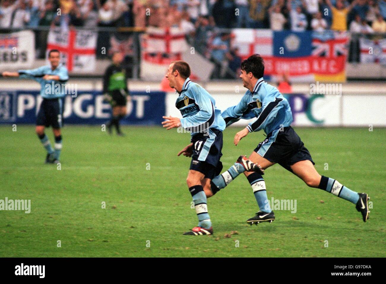 Leeds United goalscorer Lee Bowyer wheels away after scoring the third goal chased by Ian Harte