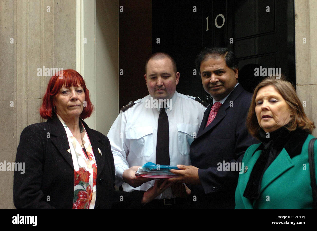 Barbara Dunne (left), from Whinney Banks in Middlesbrough, presents a petition at No 10 Downing Street in central London, Tuesday March 7, 2006, with Ashok Kumar, MP for Middlesbrough South and East Cleveland and Joan McTigue, MP for Middlesbrough. The petition calls for a ban on the selling of dangerous knives on the high street and on the internet and follows the killing of Barabara's son, Robert, after he was attacked with a samurai sword in January 2003. Watch for PA story. PRESS ASSOCIATION PHOTO. Photo credit should read: Johnny Green/PA. Stock Photo