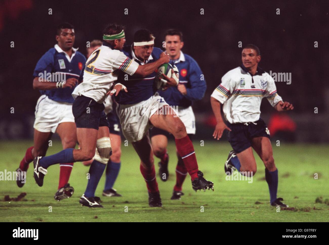 Rugby Union - Rugby World Cup 99 - Pool C - France v Namibia. L-R; Nambia's Schalk van der Merwe tackle's France's Abdelatif Benazzi Stock Photo