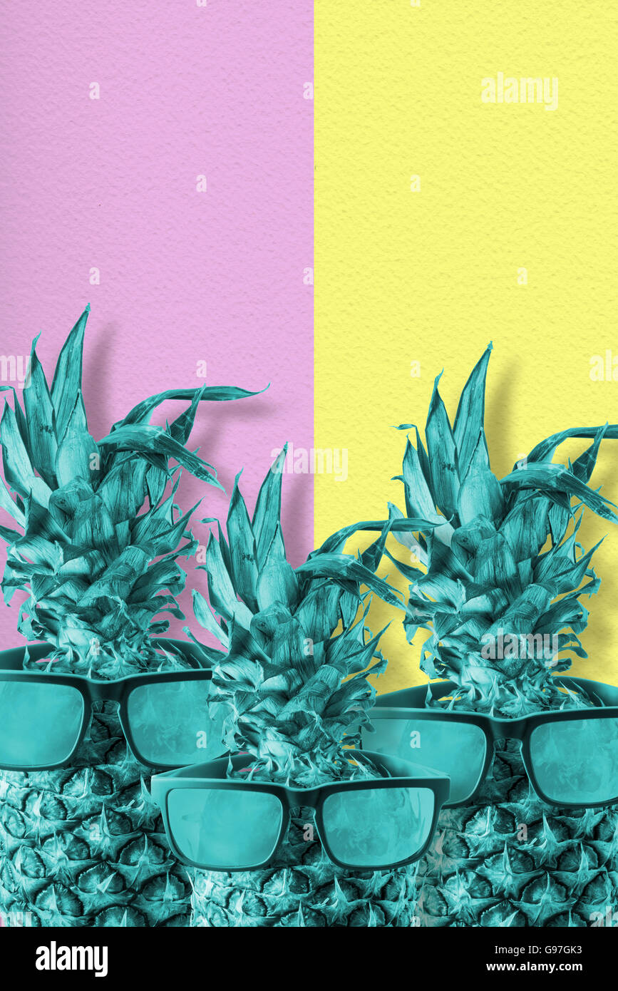 Trendy tropical pineapple fruit with sunglasses in colorful retro style, happy summer concept. Stock Photo