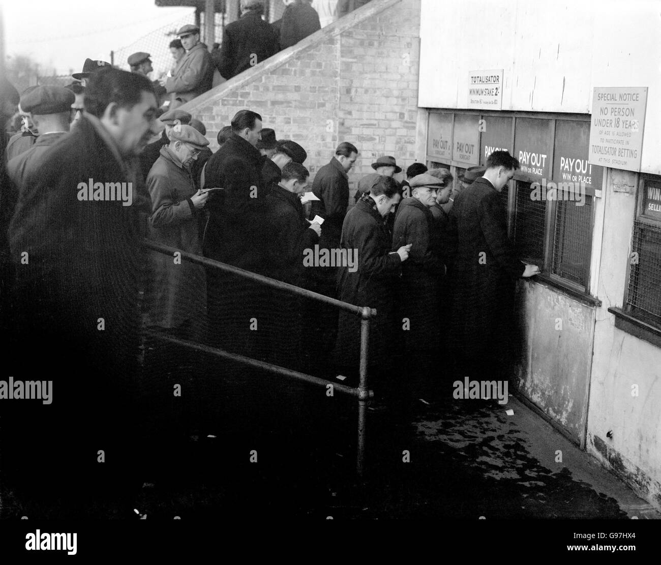 Greyhound Racing - Hackney Wick Stadium. Punters collect their winnings from the Tote Stock Photo