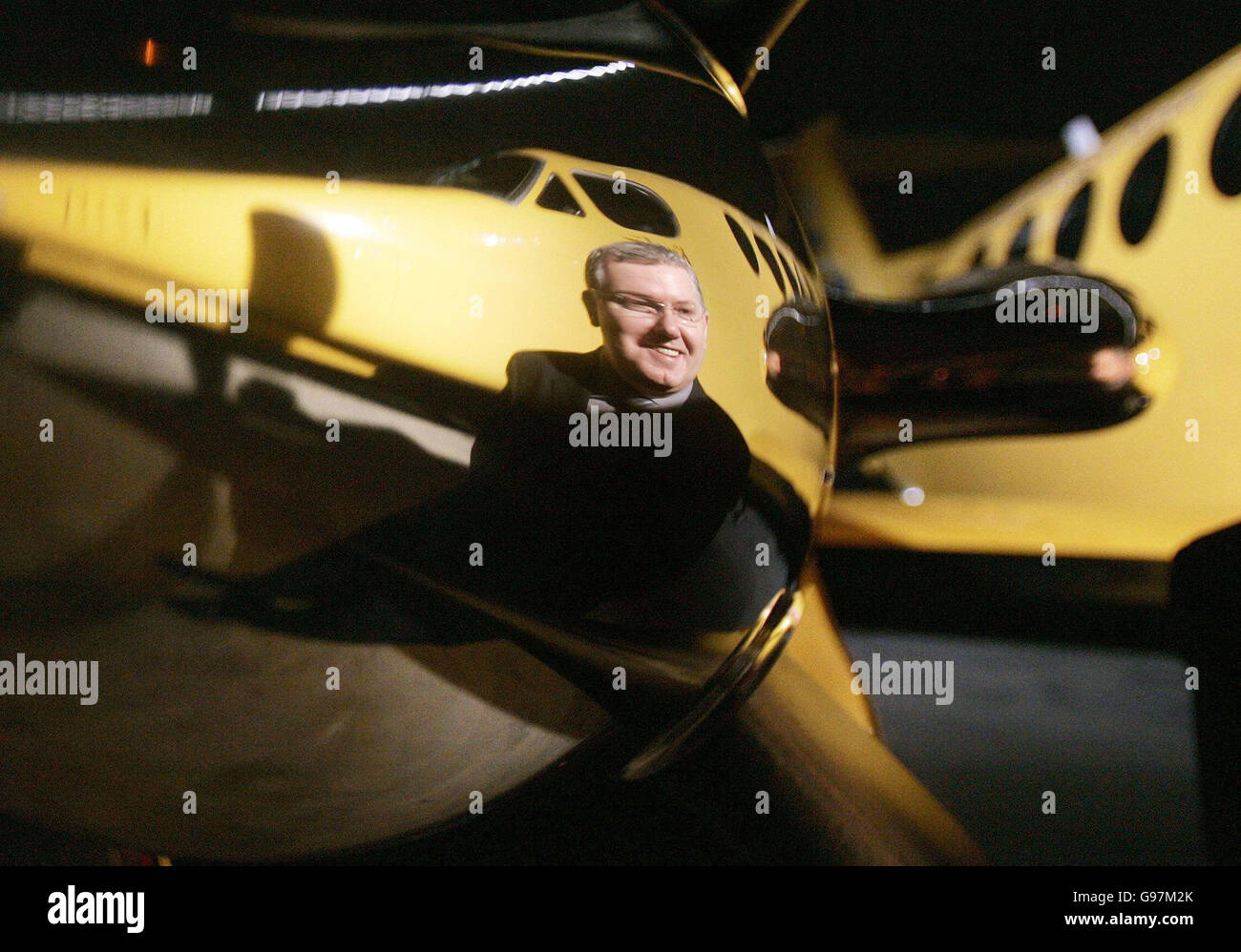 The image of Scottish Health Minister Andy Kerr is reflected in the propeller of one of two new purpose built King Air 200c aircraft at Edinburgh Airport, Monday March 20, 2006, that will form an integral part of a new world class air ambulance service for Scotland. With a range of nearly 1,700 miles, a top speed of 289 knots and space for two stretchers, they are due to start operating out of Glasgow and Aberdeen from April 1. See PA Story SCOTLAND Ambulance. PRESS ASSOCIATION Photo. Photo credit should read: Andrew Milligan/PA. Stock Photo