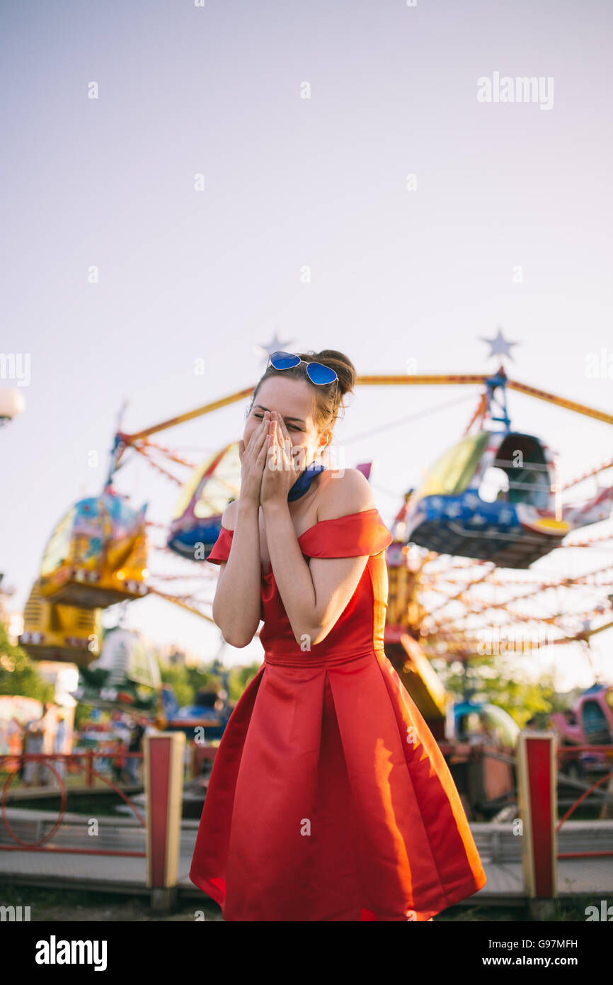 Young woman in red dress smiling Stock Photo - Alamy