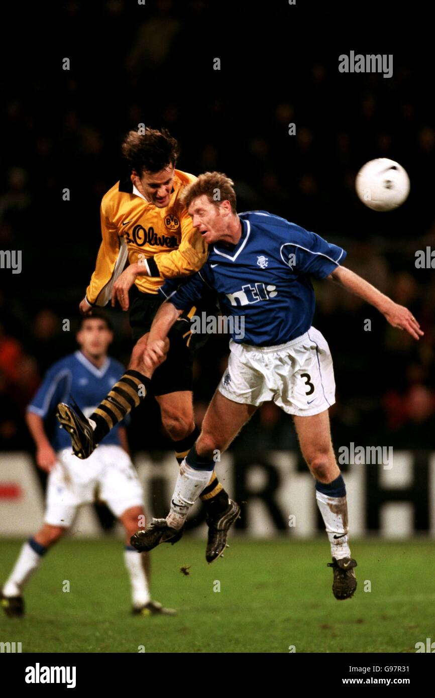 Borussia Dortmund's Heiko Herrlich beats Rangers' Craig Moore in the air Stock Photo
