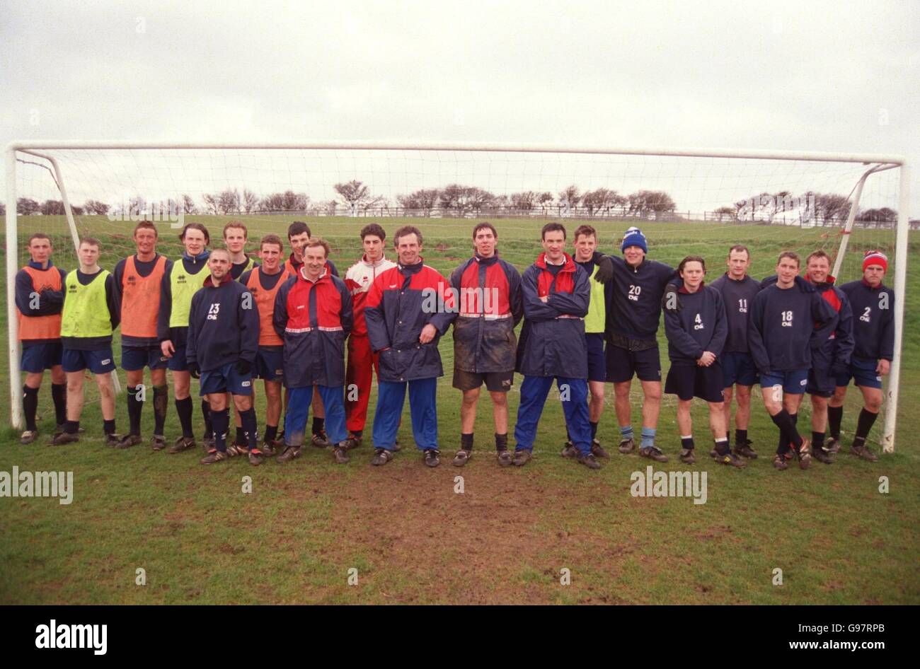 The Scarborough squad and management team standing in one of the goals at their training pitch Stock Photo