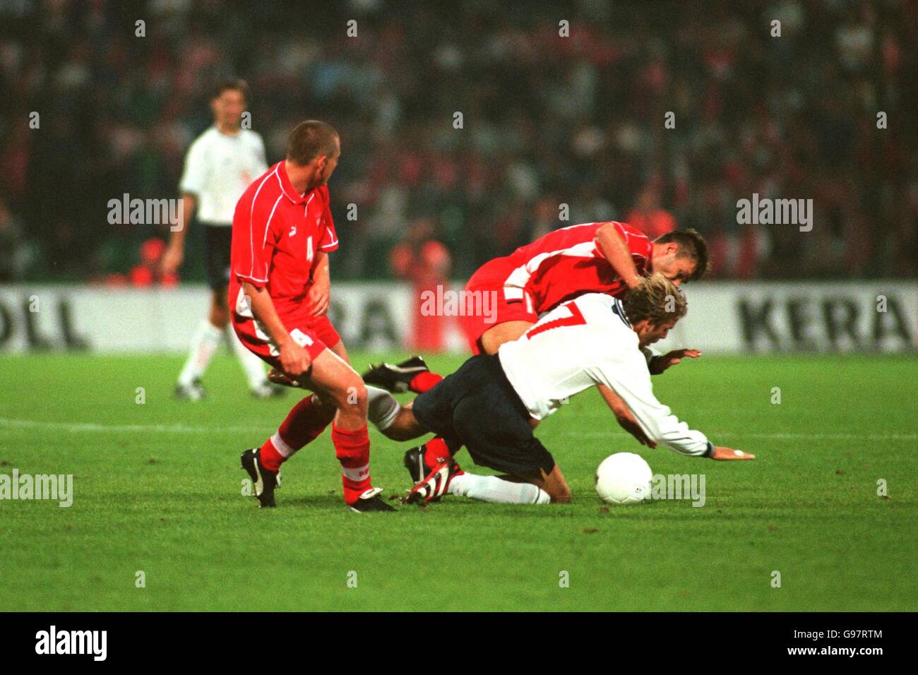 Soccer - Euro 2000 Qualifier - Group Five - Poland v England. England's David Beckham is sent flying against Poland Stock Photo