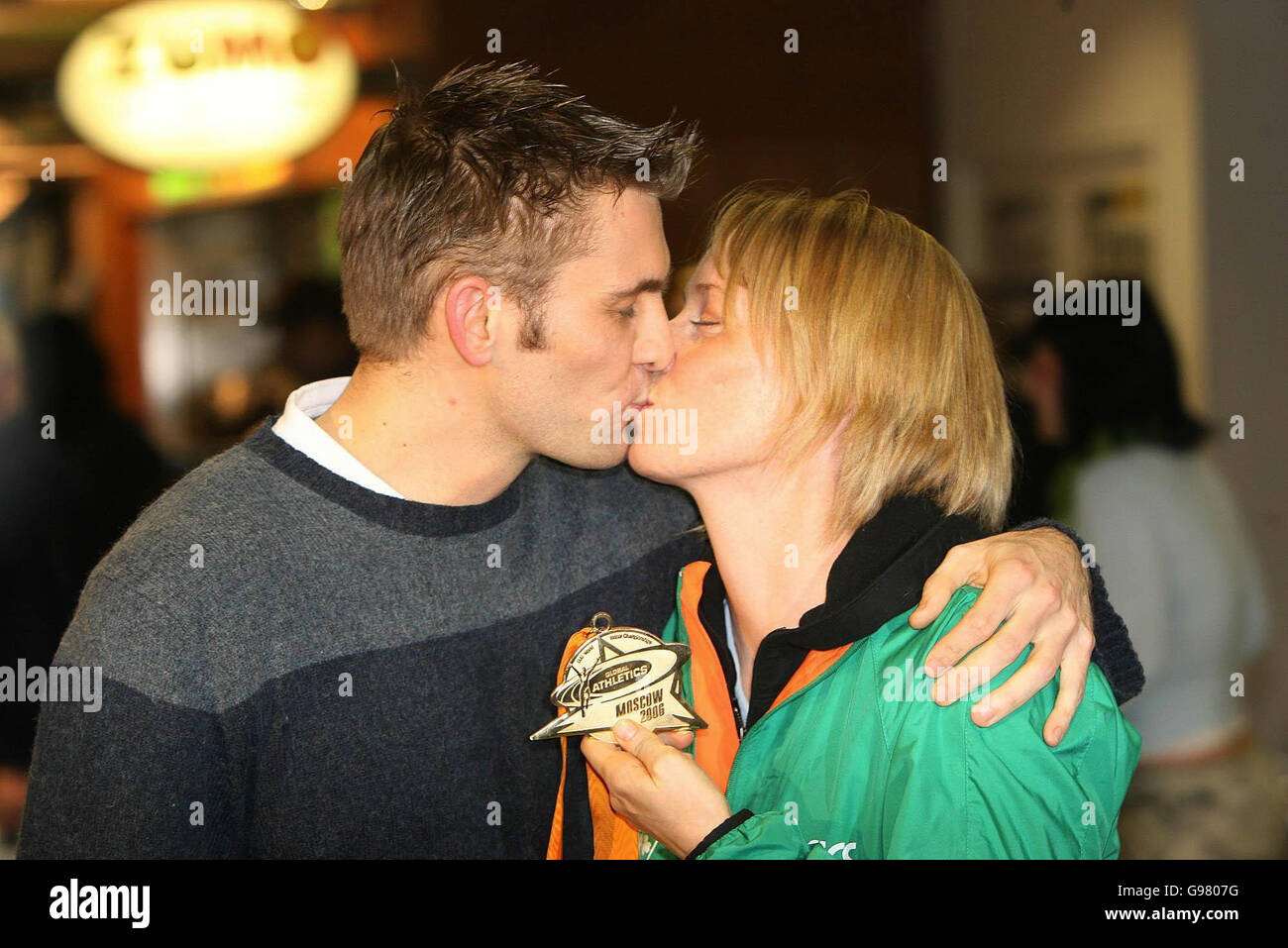 Gold Medal winning athlete Derval O'Rourke kisses her boyfriend Chris at the arrival area of Dublin airport, Monday March 13, 2006, after the 24-year-old Leevale Athletics Club runner yesterday won the Women's 60 Metre Hurdles Final and set a new Irish record time for the event. See PA Story SPORT ORourke Ireland. PRESS ASSOCIATION Photo. Photo credit should read: Niall Carson/PA Stock Photo