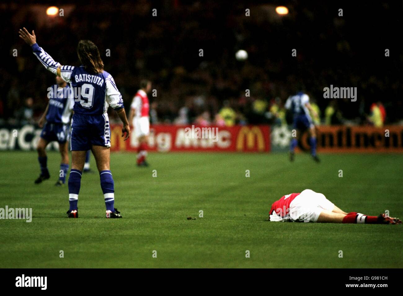 Arsenal's Lee Dixon lies injured on the ground as culprit Gabriel Batistuta of Fiorentina protests his innocence Stock Photo