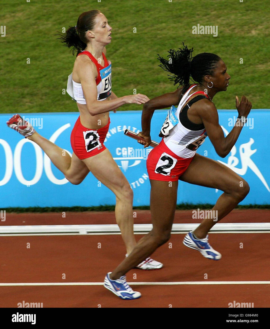 England's Nicola Sanders (L) hands the baton to Natasha Danvers to start the third leg of the Women's 4x400 metres relay final at Melbourne Cricket Ground, during the 18th Commonwealth Games in Melbourne, Australia, Saturday March 25, 2006. England's celebrations were cut short when it was announced they had been disqualified from the event with Danvers-Smith accused of blocking Tamsyn Lewis at the changeover for the third leg. PRESS ASSOCIATION Photo. Photo credit should read: Gareth Copley/PA. Stock Photo