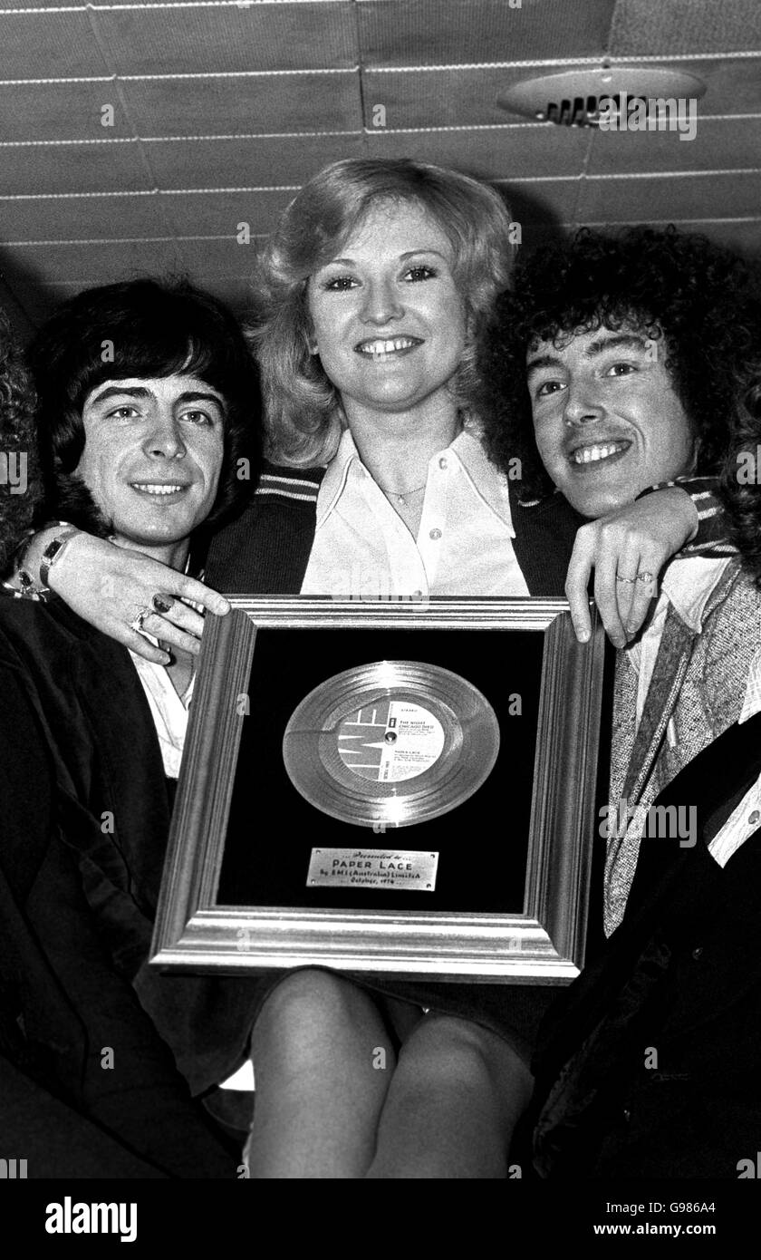 Singer Lyn Paul, is given a lift up by the pop group Paper Lace, while she exhibits an award - the group gained two gold record awards for the Australian sales of their discs - which she presents before they leave for a tour of Canada and the US. Phil Wright (left) with Cliff Fish from the band. Stock Photo