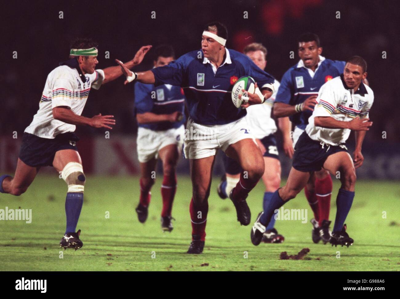 Rugby Union - Rugby World Cup 99 - Pool C - France v Nambia. France's Abdelatif Benazzi fends off a challenge from Nambias Schalk van der Merwe Stock Photo
