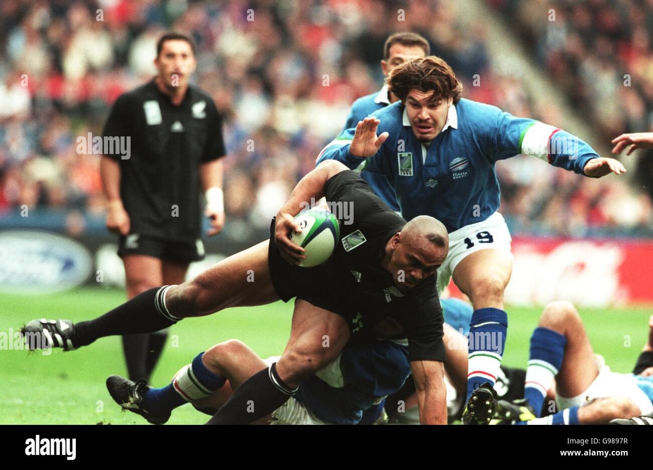 New Zealand All Blacks winger Jonah Lomu is held up for a moment before