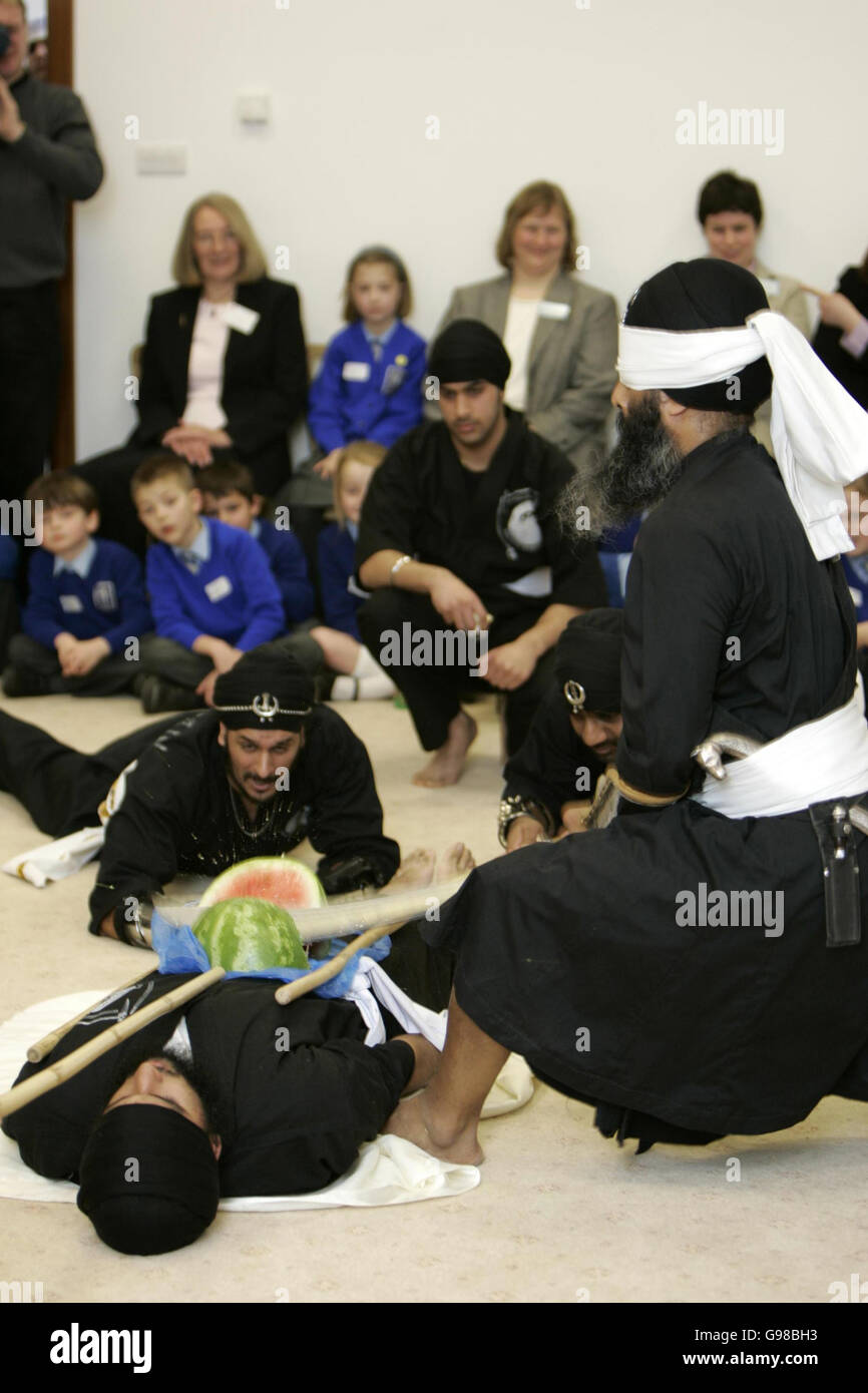 Blindfolded Swordsman Uptej Singh chops a water melon on a persons stomach during a visit by The Prince of Wales and the Duchess of Cornwall to one of Britain's biggest Sikh temples, Monday 13 March 2006 the Gurdwara Sri Guru Singh Sabha in Hounslow, west London. During the visit Charles and Camilla met community elders, temple volunteers and local schoolchildren. The event marks Commonwealth Day and comes a fortnight ahead of the royal couple's official visit to India. See PA Story ROYAL Commonwealth Temple. PRESS ASSOCIATION Photo. Photo credit should read: Michael Dunlea/PA/NPA Pool/Daily Stock Photo