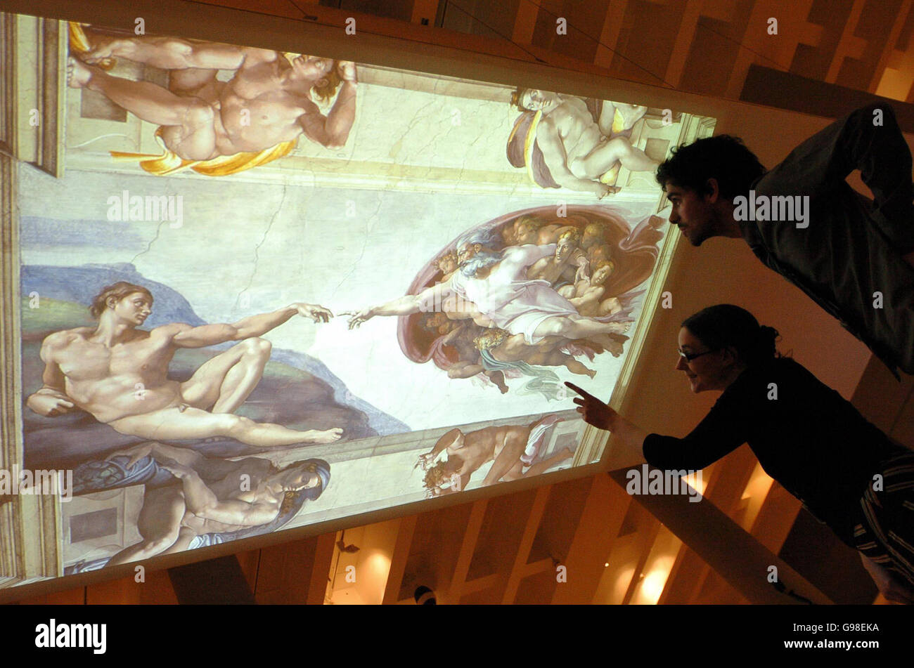Staff at the British Museum view an illuminated ceiling showing the 'Creation of Adam' by the Renaissance artist Michelangelo at an exhibition called 'Closer To The Master'. The exhibition is being previewed at the museum, Monday March 20, 2006, prior to its opening on Thursday. It's museum's first showing of the artist's works for thirty years. PRESS ASSOCIATION Photo. Photo credit should read: Ian Nicholson/PA Stock Photo