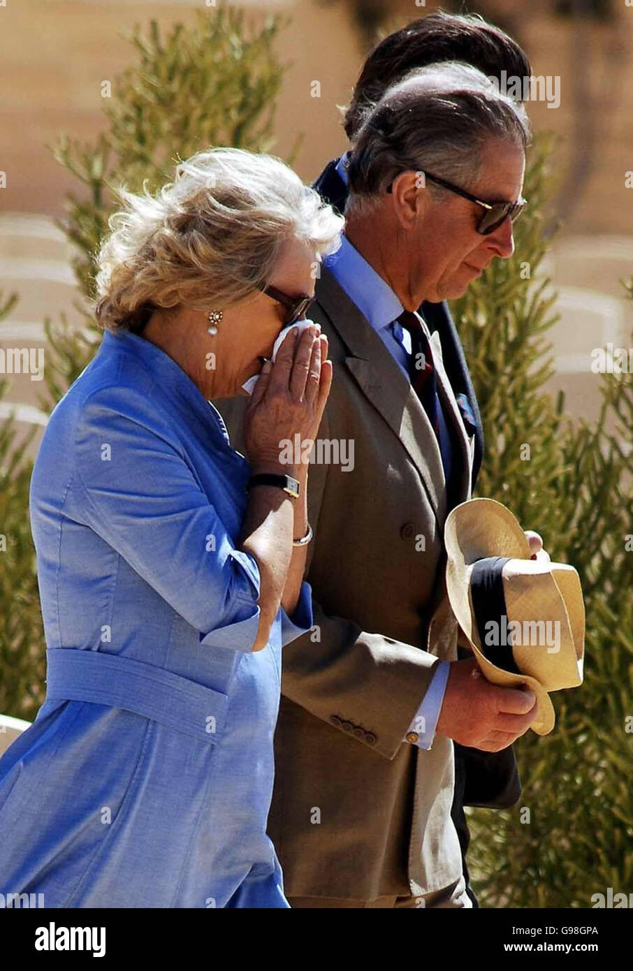 *Recrop of ROYAL Charles 1* The Prince of Wales and Duchess of Cornwall amongst the gravestones in the Commonwealth War Graves Cemetery in El Alamein, Egypt, Friday March 24, 2006. The Duchess of Cornwall paid tribute today to her father's comrades who died in front of him in the aftermath of the Battle of El Alamein. Major Bruce Shand, now 89, survived the attack in November 1942, but saw his wireless operator Sergeant Charles Francis and driver Corporal Edward Plant who were travelling in the same vehicle as him, perish. Today at the cemetery in El Alamein Camilla gently placed a bunch of Stock Photo