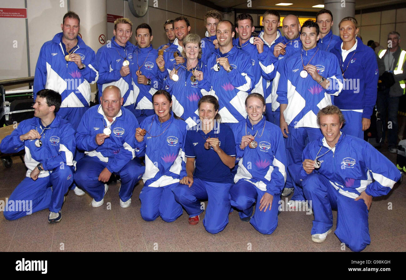 Scotland medal winners pose on arrival at Glasgow Airport, Wednesday March 29, 2006. The Scotland team returned home from the Commonwealth Games which were held in Melbourne, Australia last week. Watch for PA story. PRESS ASSOCIATION Photo. Photo credit should read: Andrew Milligan/PA. Stock Photo
