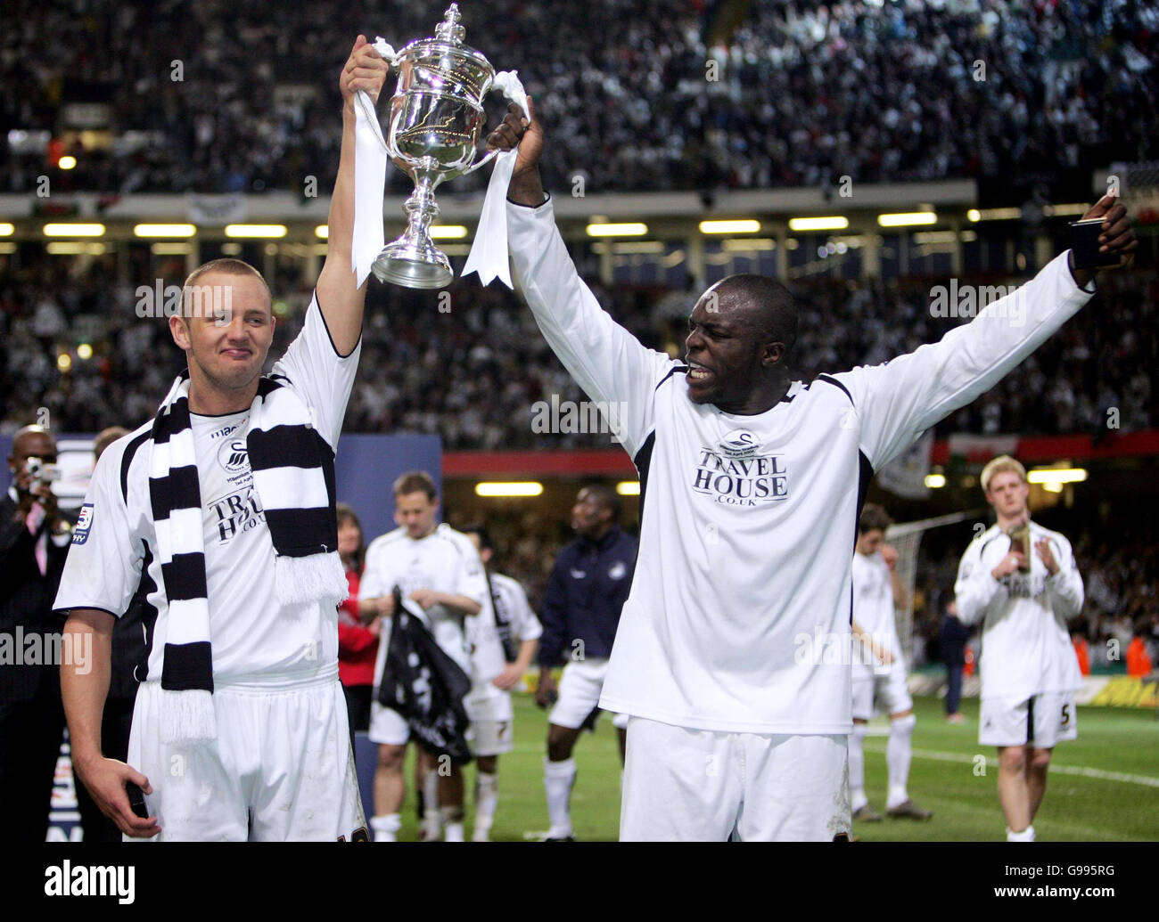 Swansea City's Lee Trundle (left) and Adebayo Akinfenwa celebrate with the trophy following their 2-1 victory against Carlisle United in the LDV Vans Trophy Final at the Millennium Stadium, Cardiff, Sunday April 2, 2006. PRESS ASSOCIATION Photo. Photo credit should read: David Davies/PA. . Stock Photo