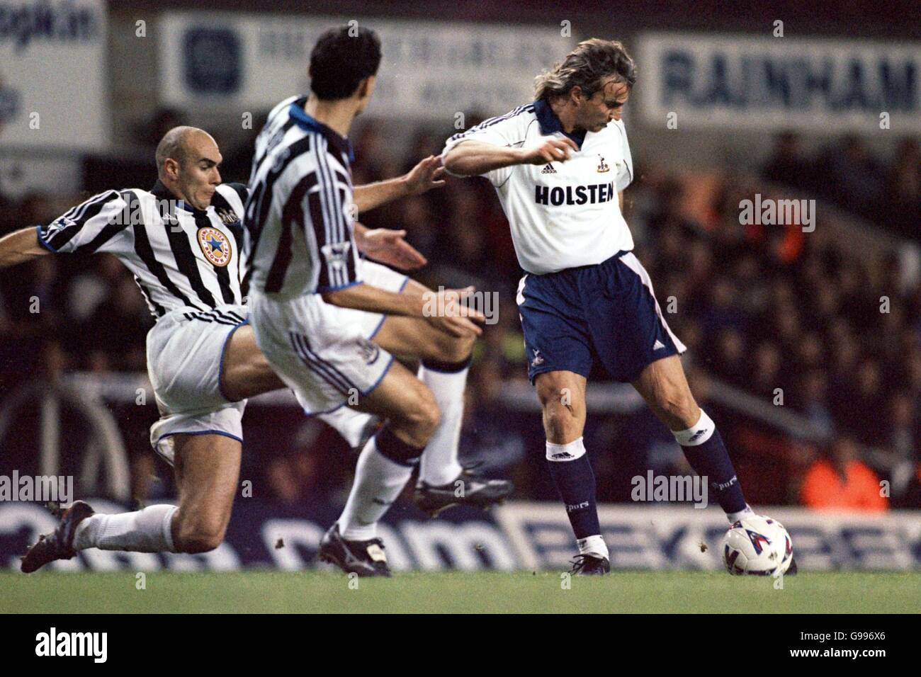 Tottenham's David Ginola fires in a shot dispite the efforts of Newcastle's Laurent Charvet & Nikolaos Dabizas Stock Photo