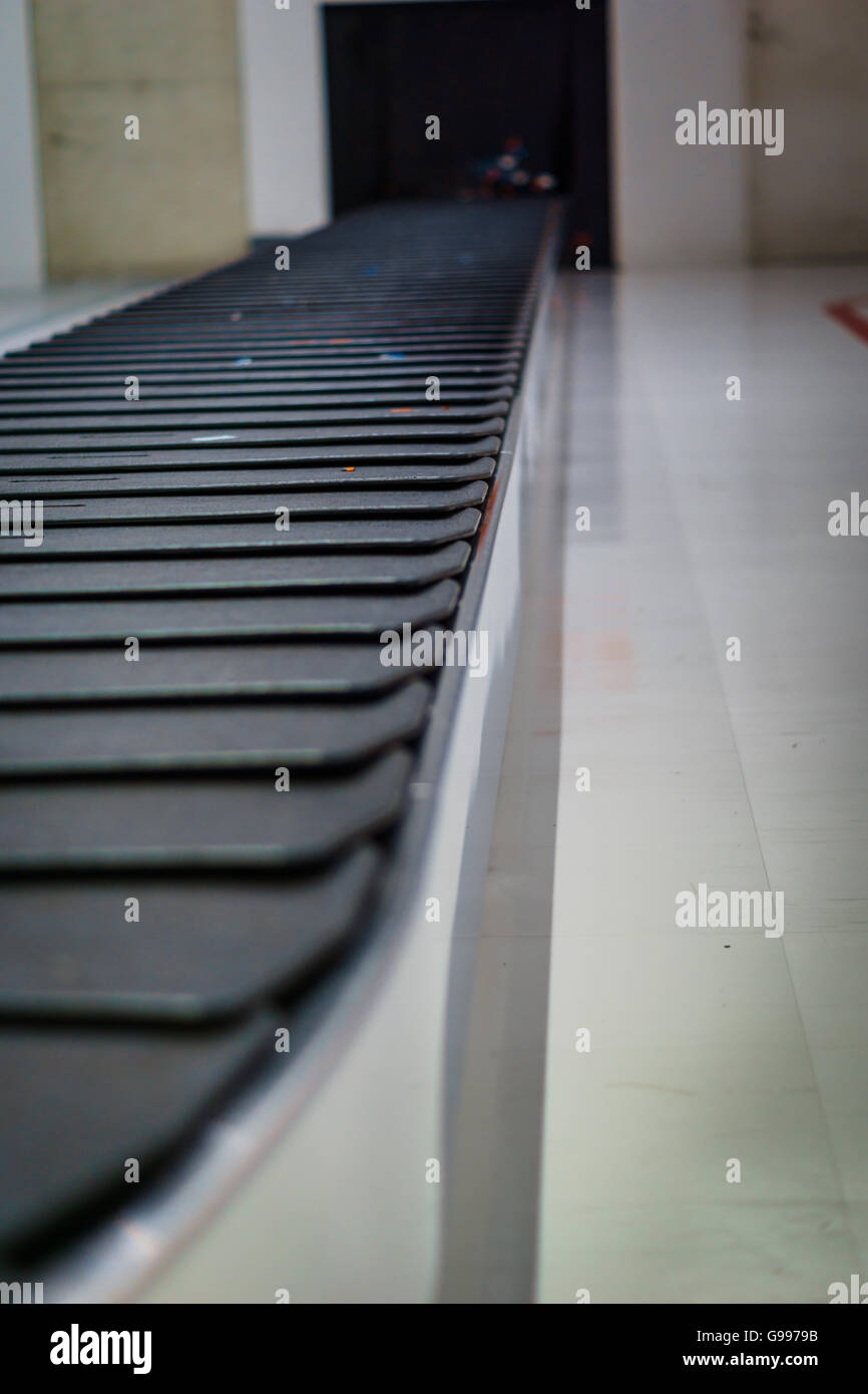 Baggage claim conveyor belt at airport - blurred Stock Photo