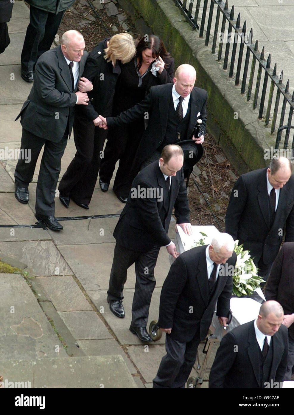 Mandy Carter (blonde hair) follows the funeral cortege of her three children, Samantha, Patricia and Marcus Carter, as it arrives at St. Edward's Church in Leek, Staffordshire, Thursday April 6, 2006. The siblings died in an alleged arson attack at their semi-detached house in Hillside Road, Cheddleton, on March 9, with their mother's partner Roderick Hine. See PA story FUNERAL Children. Stock Photo