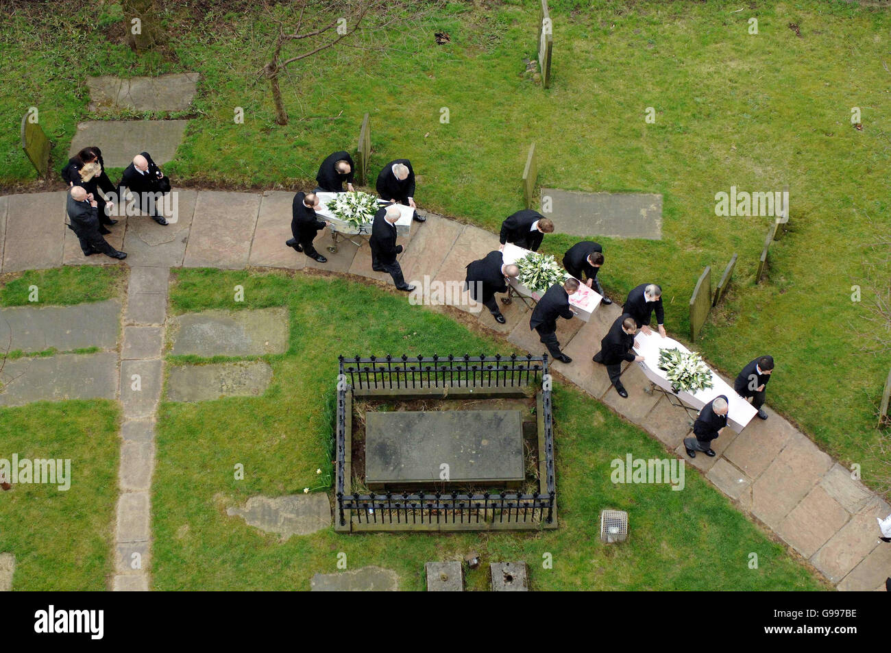 Mandy Carter (blonde hair - left of picture) follows the funeral cortege of her three children, Samantha, Patricia and Marcus Carter, as it arrives at St. Edward's Church in Leek, Staffordshire, Thursday April 6, 2006. The siblings died in an alleged arson attack at their semi-detached house in Hillside Road, Cheddleton, on March 9, with their mother's partner Roderick Hine. See PA story FUNERAL Children. Stock Photo