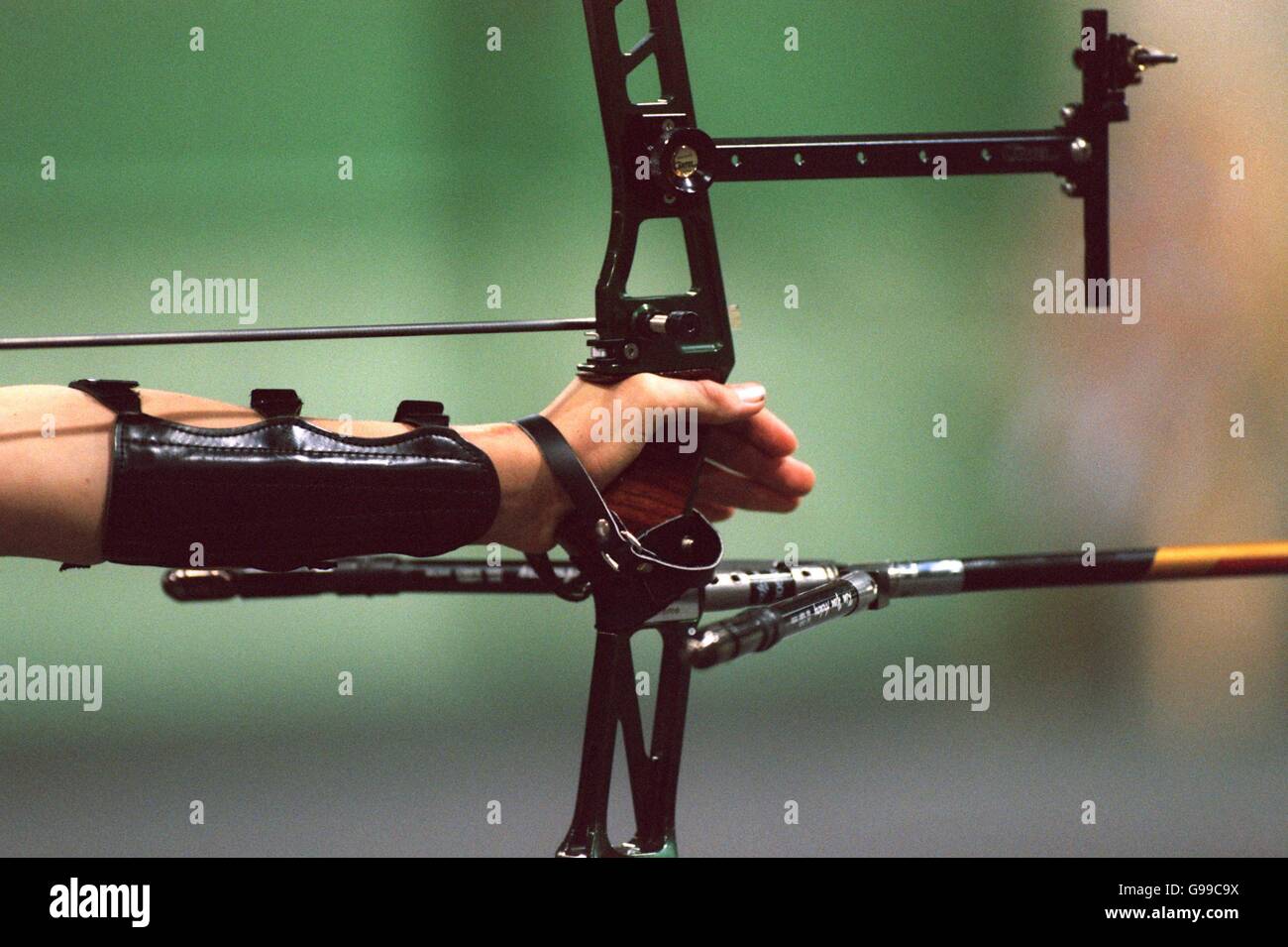 The archer's hand, protected by his arm guard, holding the bow Stock Photo Alamy