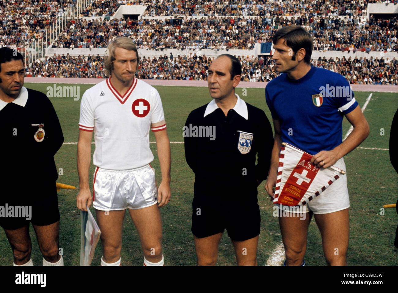 The captains of Switzerland, Karl Odermatt (white shirt), and Italy,  Giacinto Facchetti (blue shirt), greet each other before their match in Rome  Stock Photo - Alamy