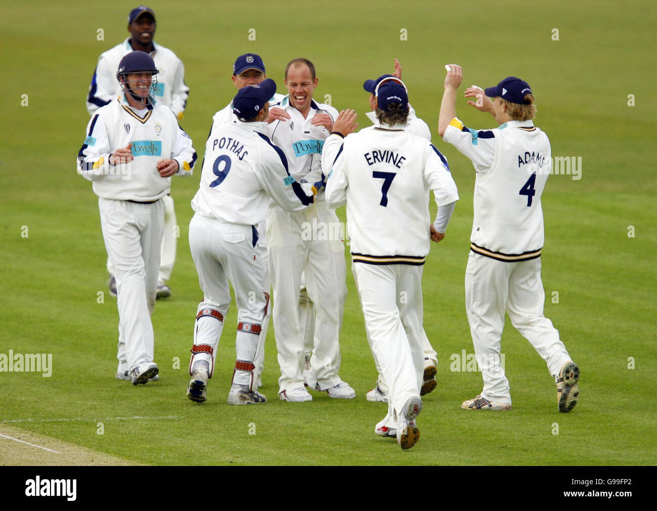 Hampshire bowler Billy Taylor (hatless centre) celebrates his first ...