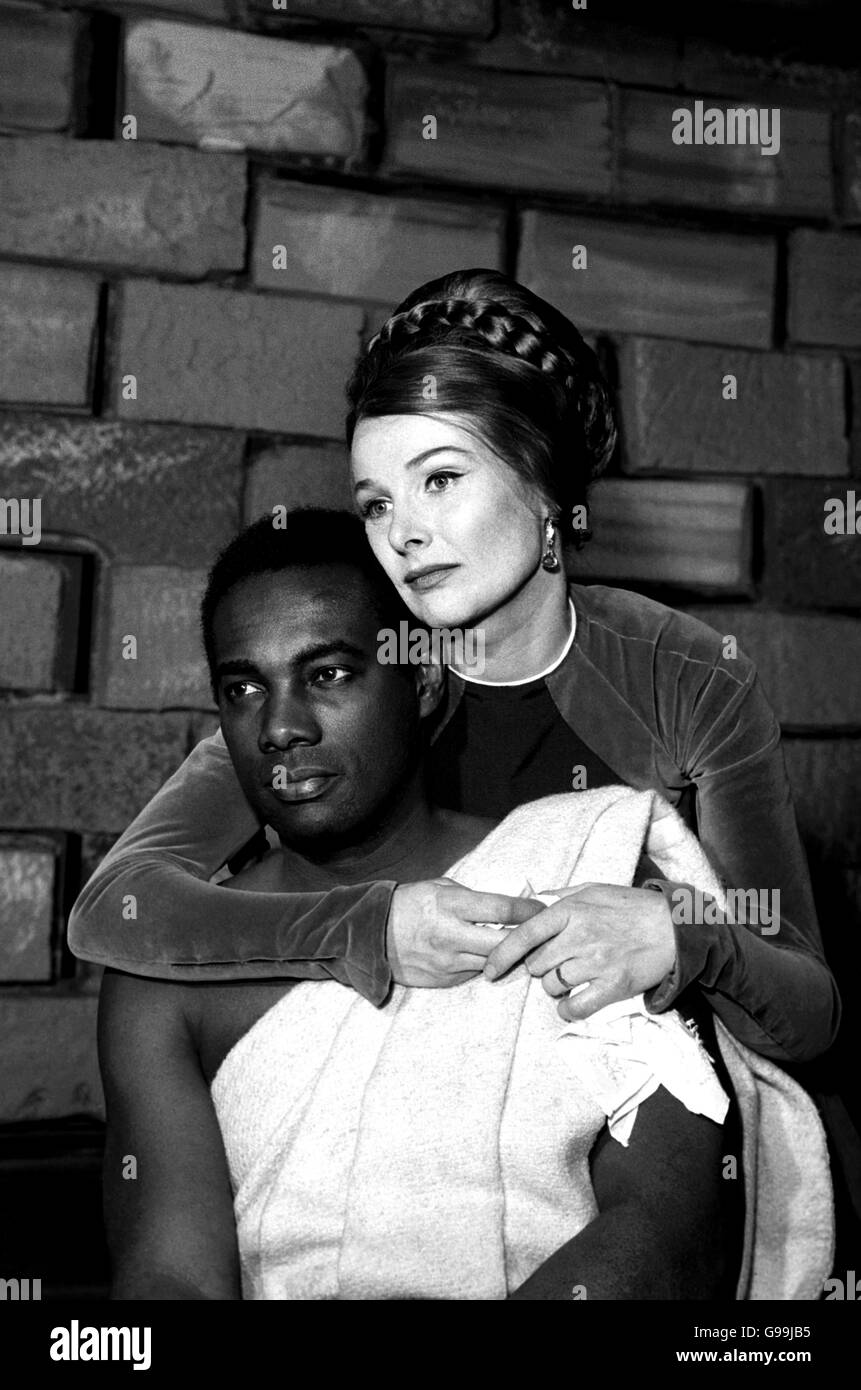 Othello - The Old Vic. Adrienne Corri as Desdemona, places her arm around the neck of Errol John as Othello during rehearsals. Stock Photo