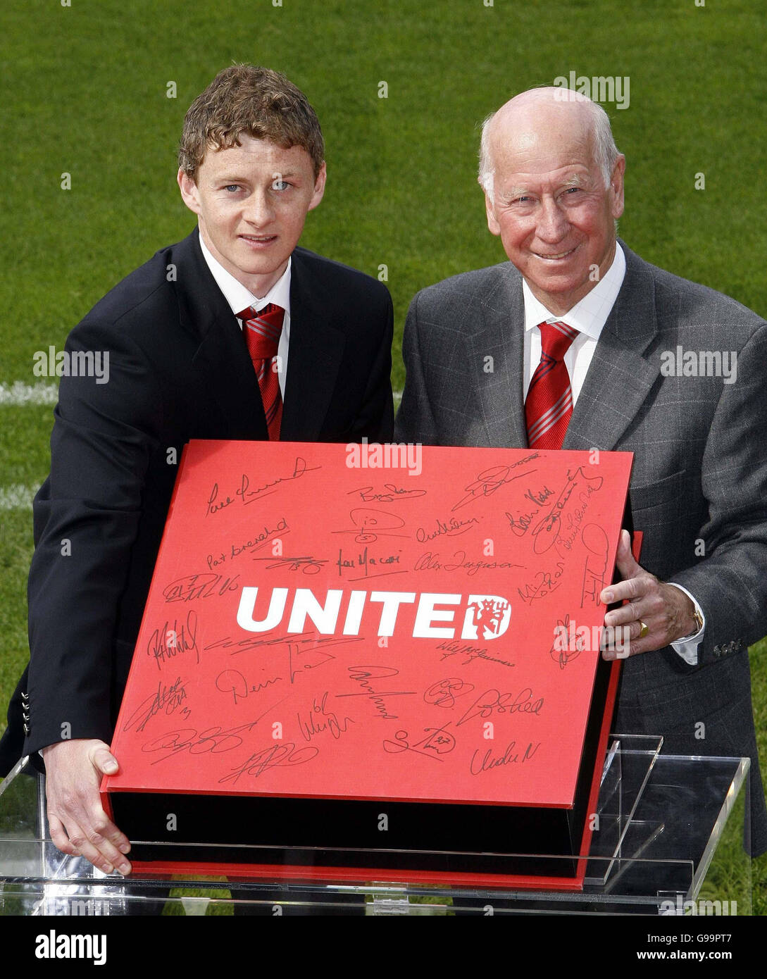 Sir Bobby Charlton (R) and Ole Gunnar Solskjaer with Manchester United's Opus Book of History during a photo-call at Old Trafford, Manchester. Stock Photo