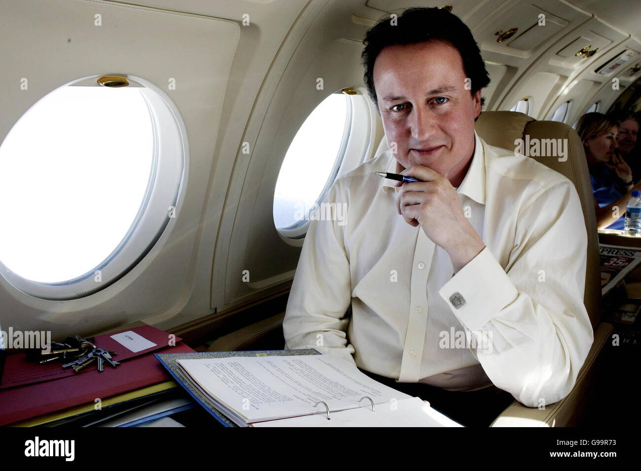 Leader of the Conservative Party David Cameron works on the plane during his flight to the island of Spitsbergen, above the Arctic Circle. Stock Photo