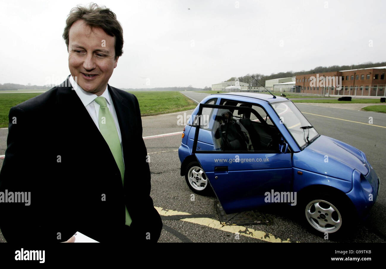 Conservative Party leader David Cameron stands in front of a Reva G-Wiz electric car at Dunsfold Park airfield in Cranleigh, Surrey, where he committed his party to slashing carbon emissions from cars on British roads by almost a third to help the fight against global warming. Stock Photo