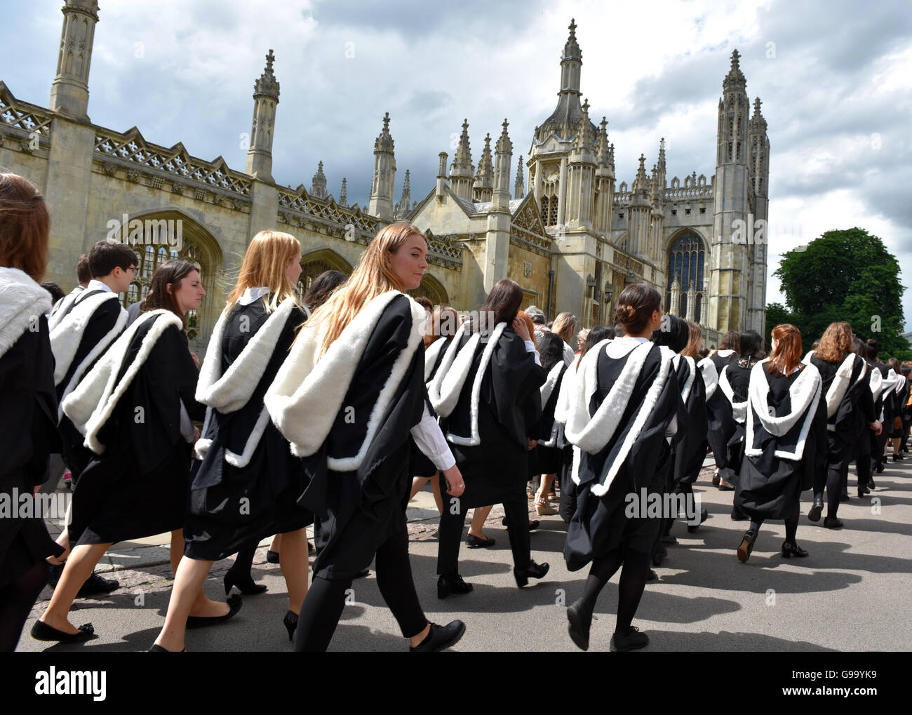A parade of students from Newnham at Cambridge University pass by Kings college on their way to graduation at the Senate House Stock Photo