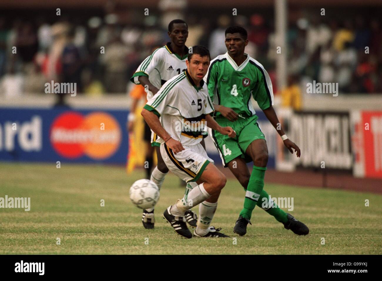 Nwankwo Kanu of Nigeria (r) passes the ball beyond South Africa's Mark Fish (l) Stock Photo