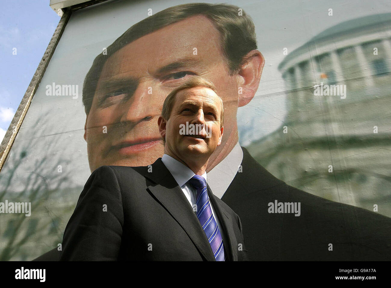 Fine Gael Leader Enda Kenny in front of a poster of himself, outside Government Buildings, Dublin, in advance of the next general election. PRESS ASSOCIATION Photo. Picture date: Tuesday May 9 2006. PRESS ASSOCIATION Photo. Photo credit should read: Julien Behal/PA Stock Photo