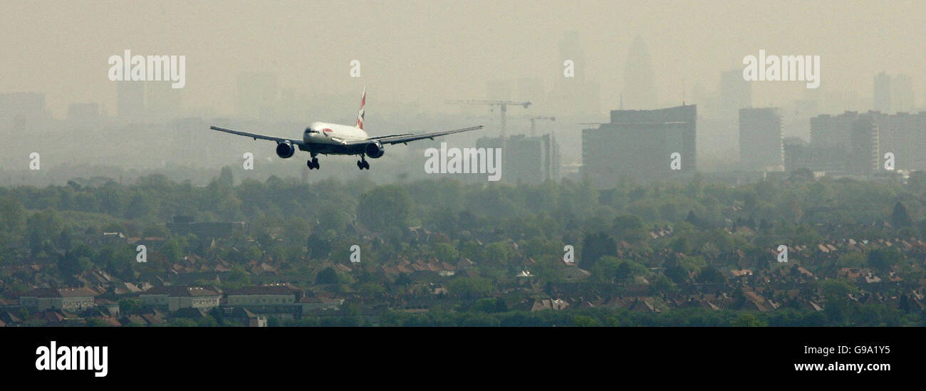 A view of a British Airways aircraft landing at Heathrow Airport with the London skyline in the distance.. A view of a British Airways aircraft landing at Heathrow Airport with the London skyline in the distance. Stock Photo