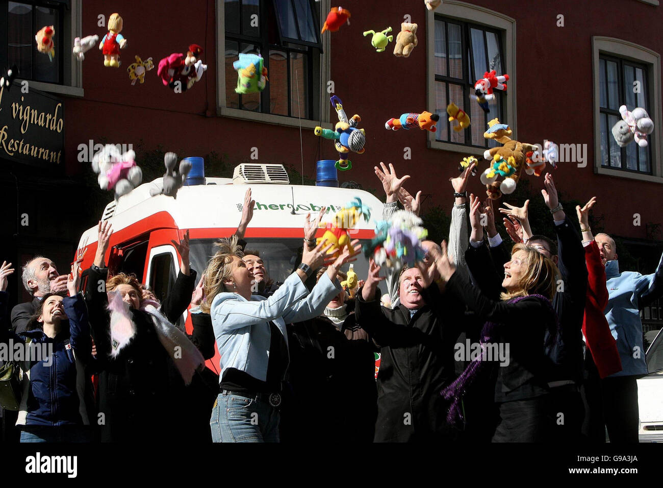 Staff from the Irish Dept of Social and Family Affairs throw donated childrens toys into the air beside a special ambulance, Dublin, Monday April 3 2006, which will be travelling to Belarus as part of a convoy to mark the 20th anniversary of the Chernobyl disaster. PRESS ASSOCIATION Photo. Photo credit should read: Julien Behal/PA Stock Photo