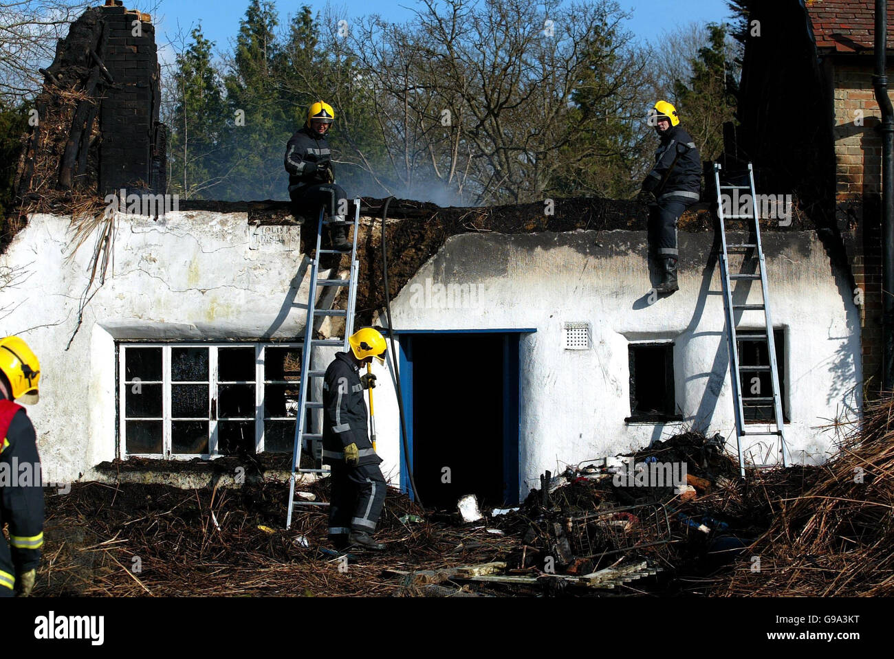 Firefighters make safe the wreckage of film director Ken Russell's home after it was destroyed by fire, Monday April 3 2006. The thatched cottage in East Boldre in the New Forest, Hampshire was engulfed by flames while Mr Russell was at the Post Office. See PA story FIRE Russell. PRESS ASSOCIATION photo. Picture credit should read: Chris Ison/PA Stock Photo
