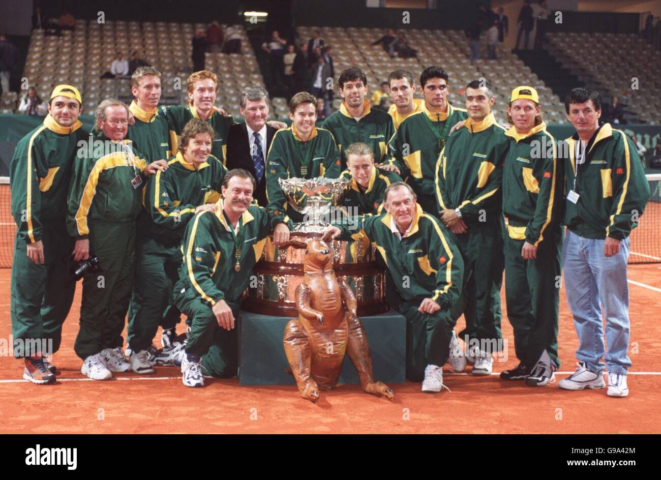 The Australian team with a blowup kangaroo celebrate with the Davis Cup after beating France in