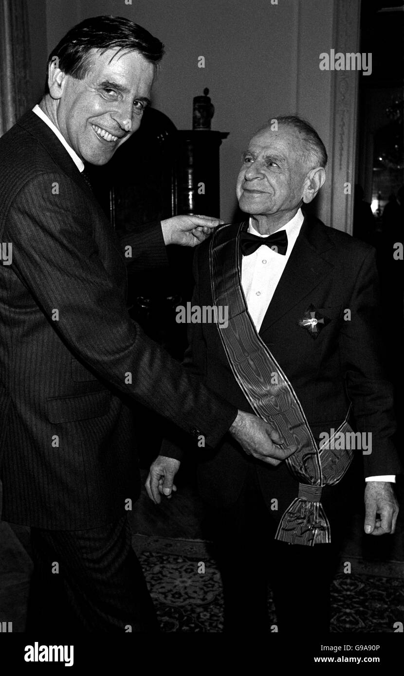 Philosopher Sir Karl Popper, 80, wearing the sash of the Grand Crosss of the Order of Merit of the Federal Republic of Germany, which he his seen receivng from the Federal Republic's Ambassador, Dr Jurgen Euhfus, for the influence his ideas have on German post war political and philosophical thinking. Stock Photo