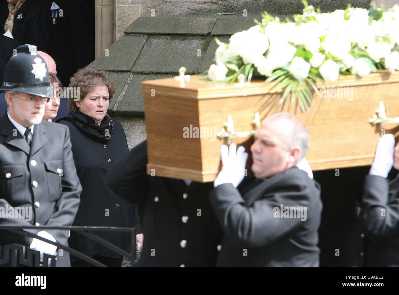 Widow Carol Carroll Looks At The Coffin At The Funeral Of Her Husband 