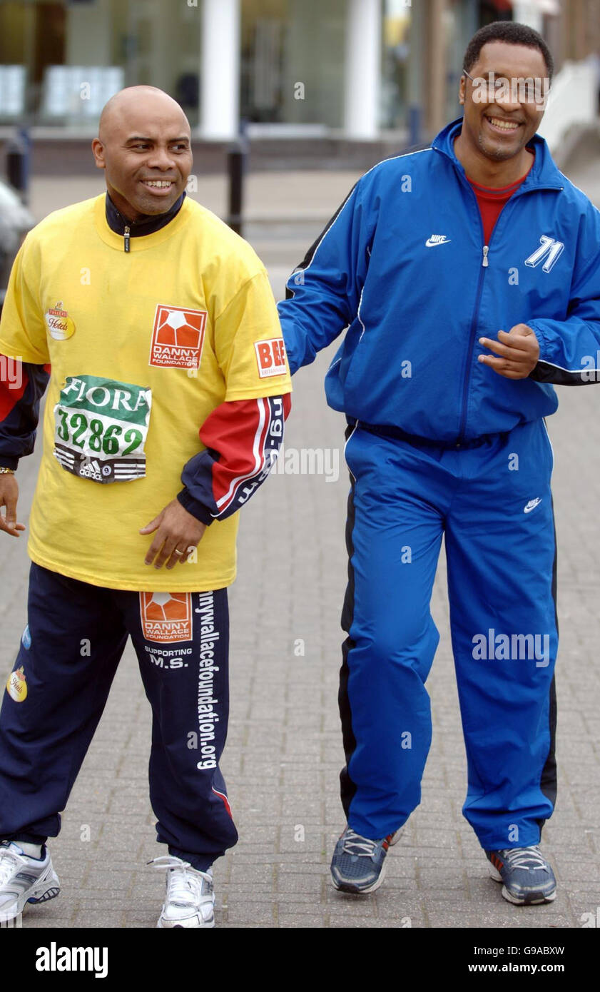 Former Manchester United footballer and MS sufferer Danny Wallace (L) meets ex-boxer Michael Watson as he continues to walk around the Flora London marathon course. Stock Photo