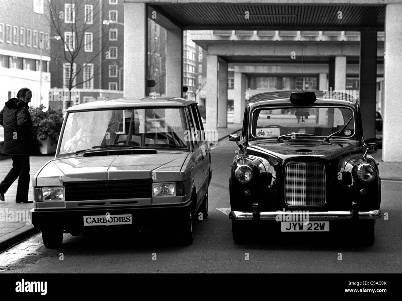 One of the 20,000 black cabs (right), lined up beside the new look taxi, based on the Range Rover. Stock Photo