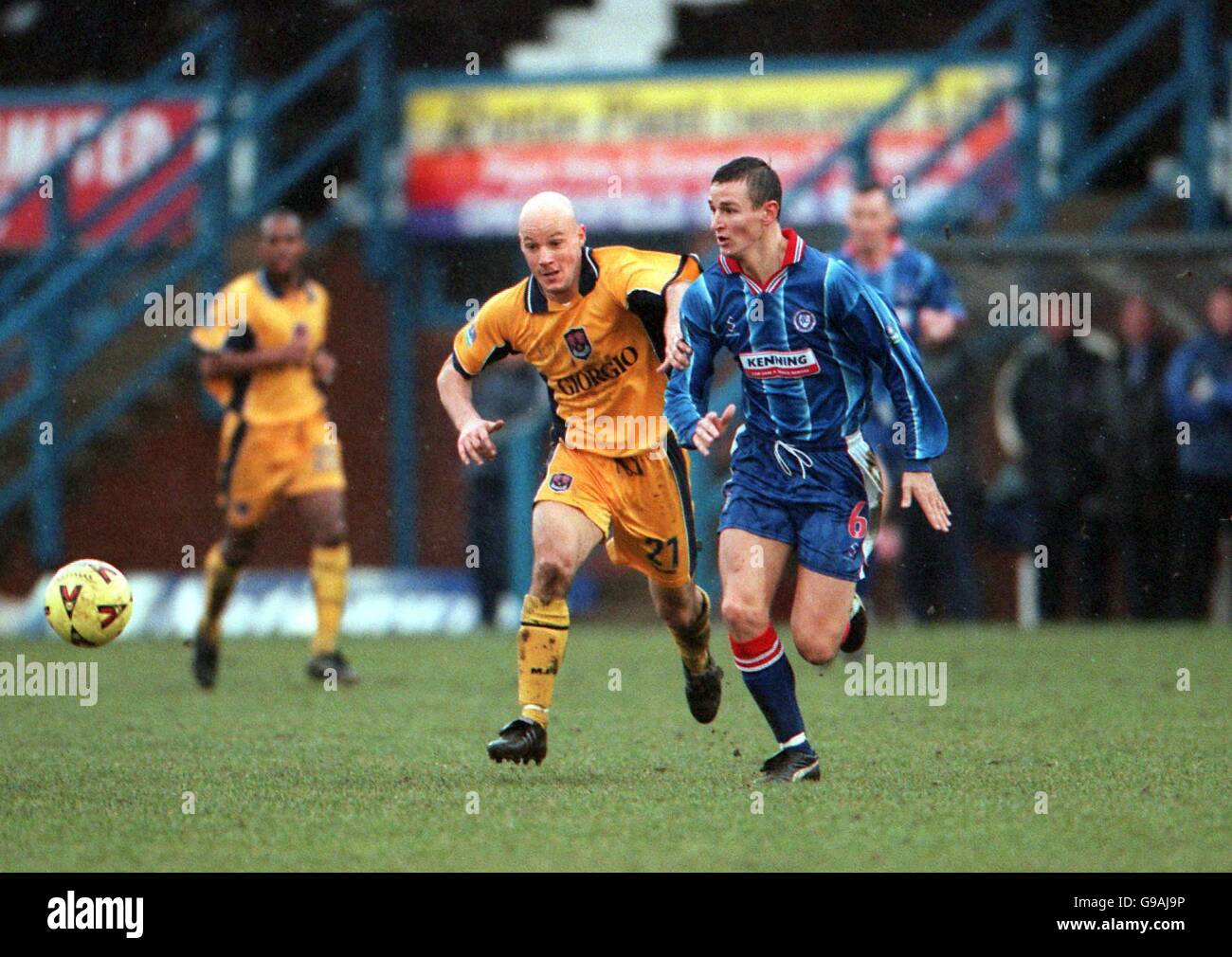 L-R Millwall's Paul Shaw attempts to escape from the challenge of Chesterfield's Ian Breckin Stock Photo