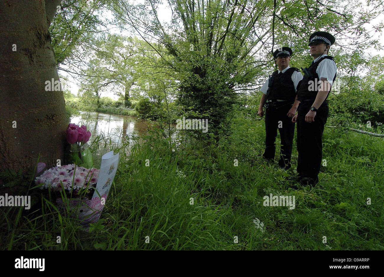 Warwickshire Police on a river bank near Aston Cantlow where a baby's body was discovered. The newborn baby girl found dead in a plastic bag near a river had suffered several serious injuries, including a fractured skull and collarbone, police said today. Stock Photo