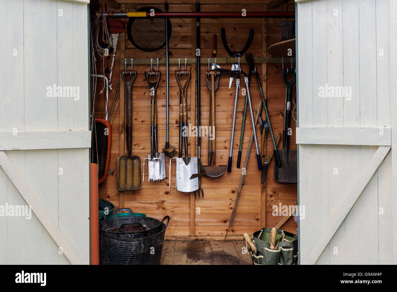 Close up of garden shed, double doors open.Garden tools, equipment. Stock Photo